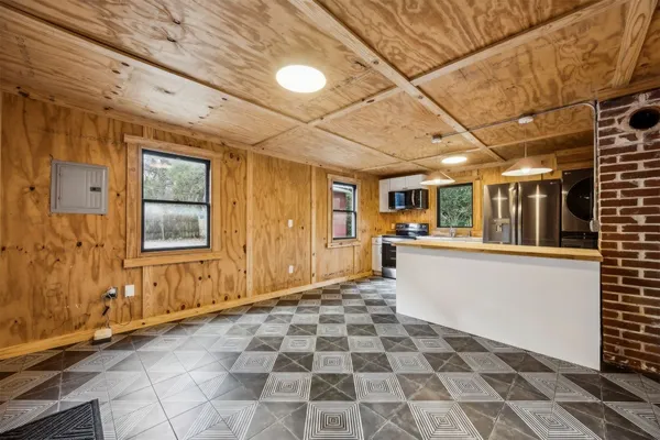 a view of a porch with wooden floor and windows