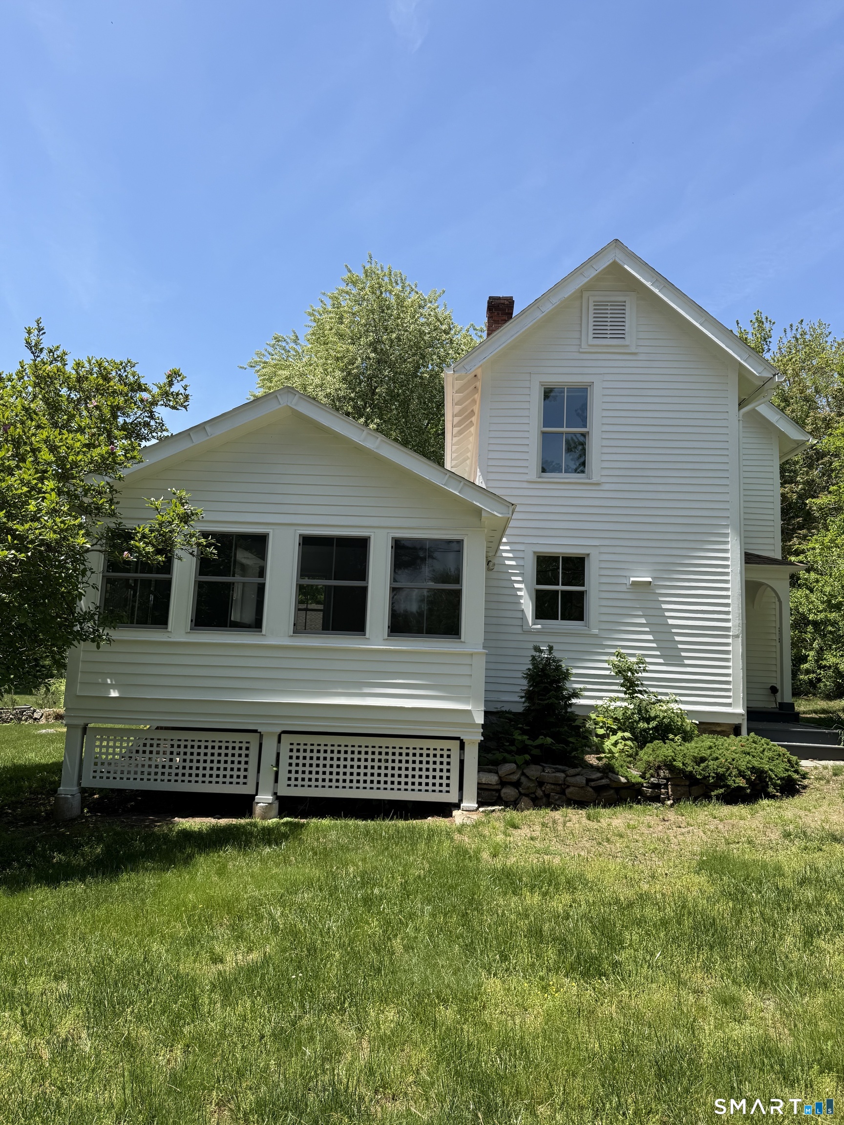 312 Ferry Road Old Lyme, CT 06371 - Photo 2 of 16 a house view with a garden space