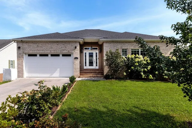 a front view of a house with garden