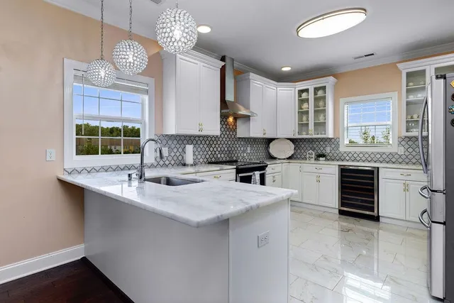 a kitchen with granite countertop a stove sink and cabinets