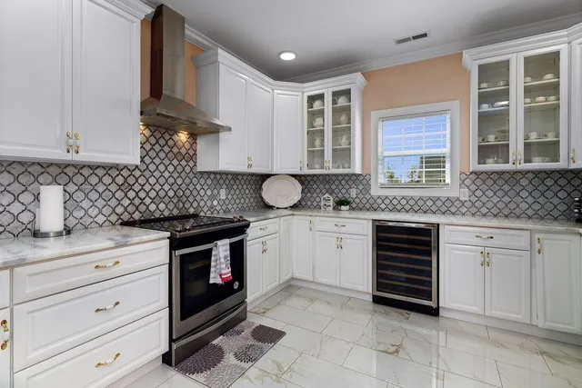 a kitchen with stainless steel appliances white cabinets and a sink
