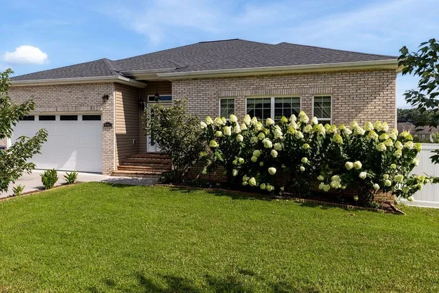 a front view of a house with a garden