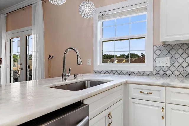 a bathroom with a granite countertop toilet and sink