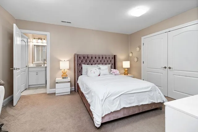 a bathroom with a granite countertop sink a toilet and a mirror