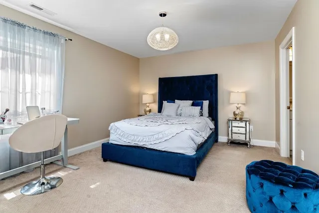 a view of washer and dryer with bathroom in the background