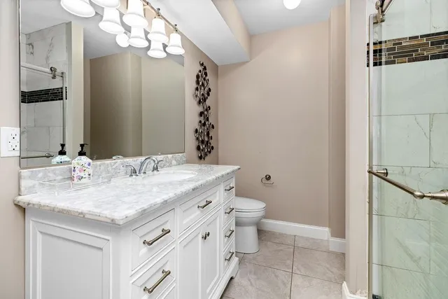 a view of a roof deck with table and chairs a barbeque with wooden floor and fence