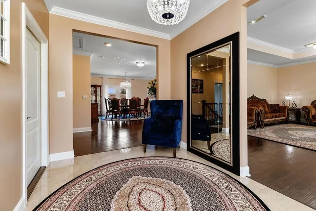 a view of a hallway with livingroom and furniture
