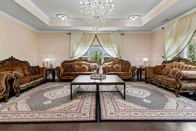 a living room with furniture a table and a chandelier
