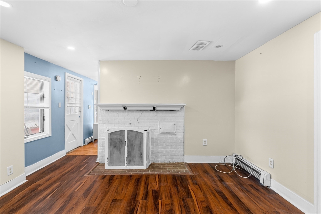 192 East Spring Street Avon, MA 02322 - Photo 15 of 25 a view of a room with wooden floor and staircase