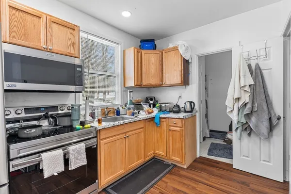 a kitchen with stainless steel appliances granite countertop a sink stove and refrigerator