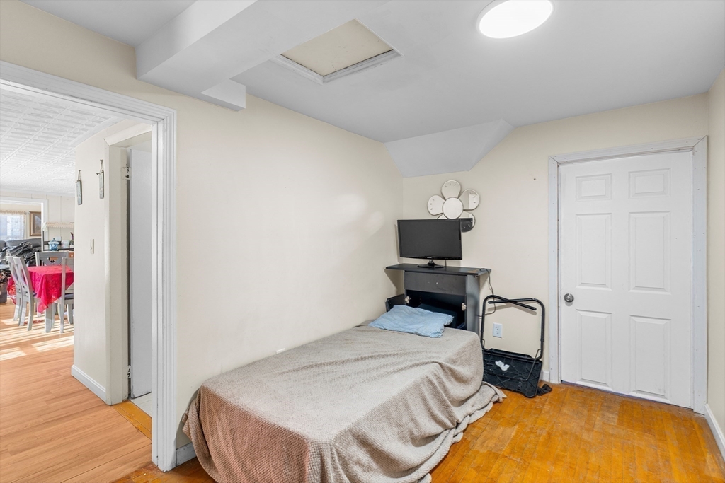 192 East Spring Street Avon, MA 02322 - Photo 25 of 25 a bedroom with a bed and wooden floor