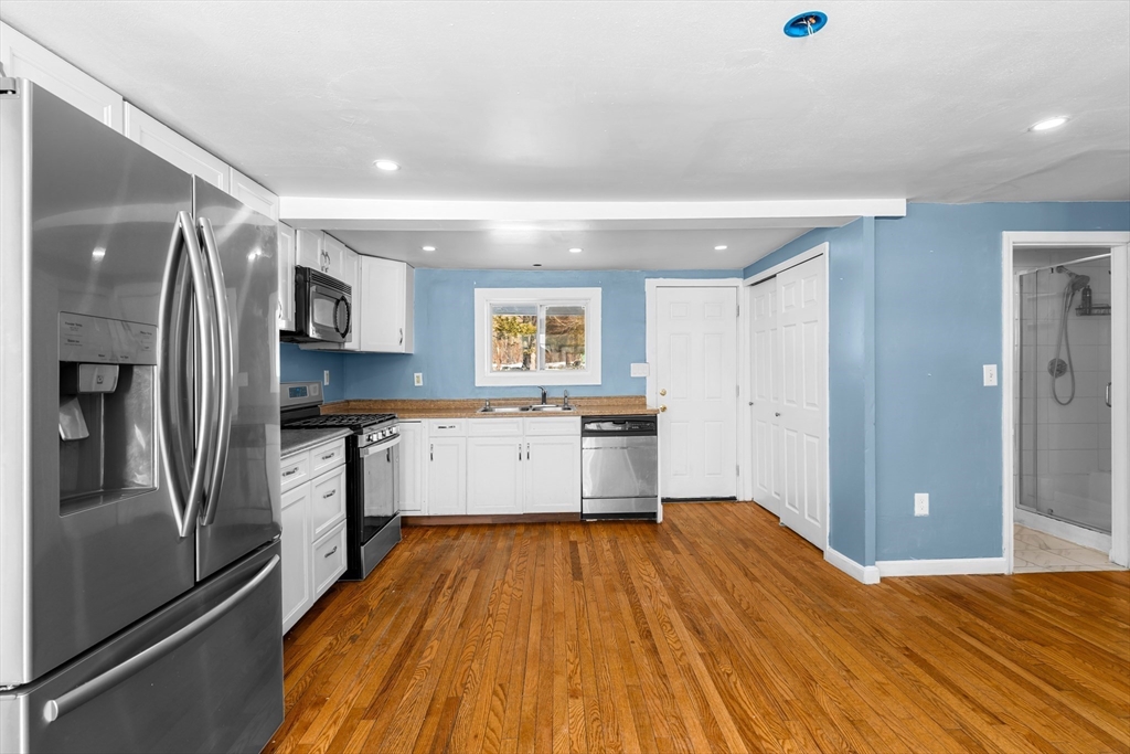 192 East Spring Street Avon, MA 02322 - Photo 5 of 25 a kitchen with stainless steel appliances granite countertop a refrigerator and a sink