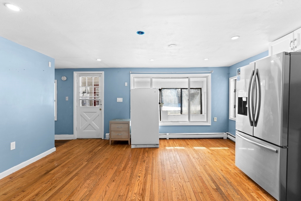 192 East Spring Street Avon, MA 02322 - Photo 6 of 25 a view of kitchen with wooden floor electronic appliances and window