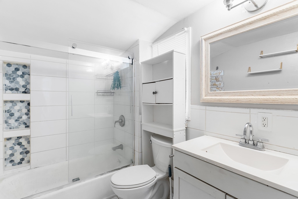 192 East Spring Street Avon, MA 02322 - Photo 10 of 25 a bathroom with a sink a toilet and shower