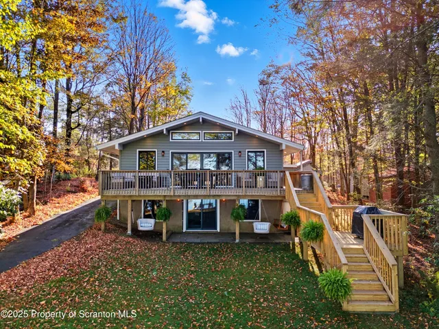 a front view of house with yard and trees