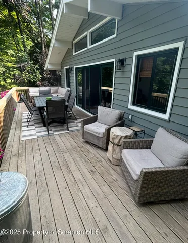 a living room with furniture a rug and a floor to ceiling window