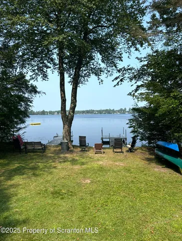 a living room with furniture a fireplace and a large window