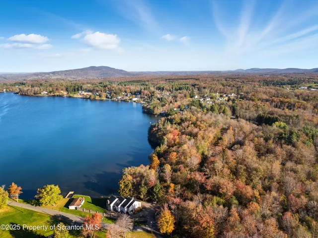 a spacious bedroom with a large bed and a large window
