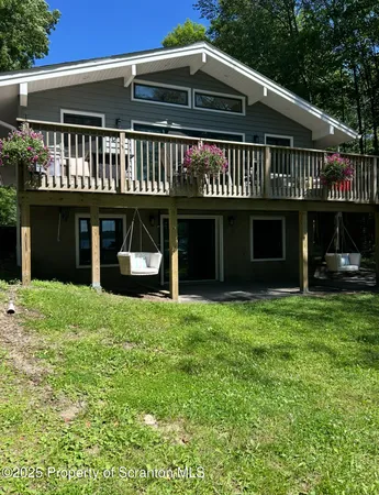 an aerial view of a houses with a lake view