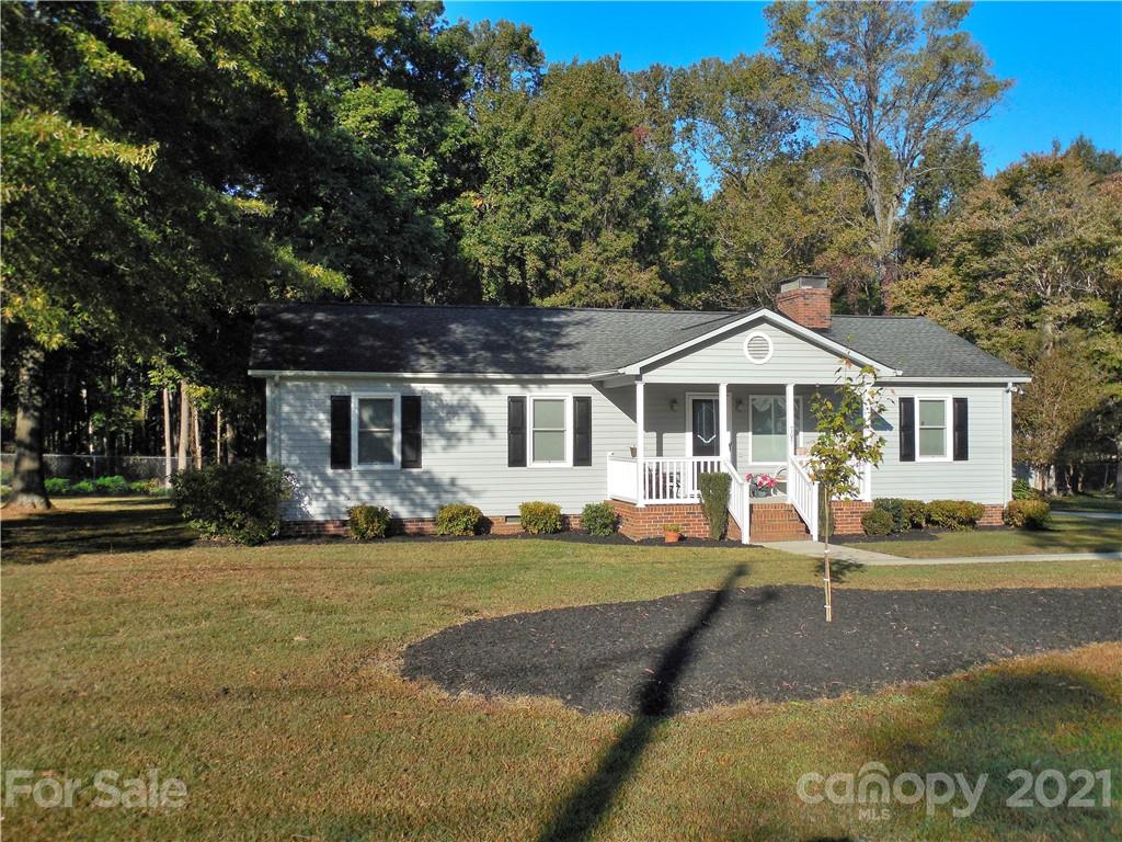 a front view of a house with a yard table and chairs