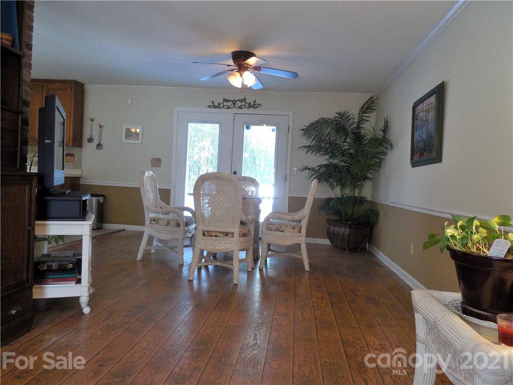 705 Washington Lane Kannapolis, NC 28083 - Photo 11 of 31 a dining room with furniture potted plants and wooden floor