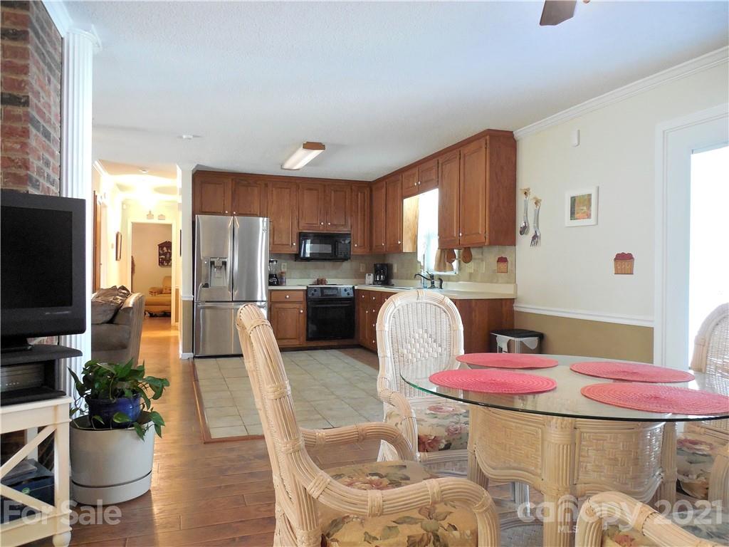 705 Washington Lane Kannapolis, NC 28083 - Photo 12 of 31 a kitchen with a refrigerator and a dining table