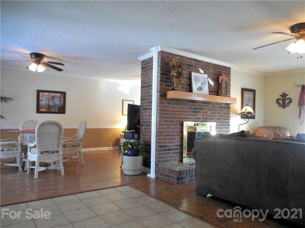 705 Washington Lane Kannapolis, NC 28083 - Photo 13 of 31 a living room with furniture a flat screen tv and kitchen view