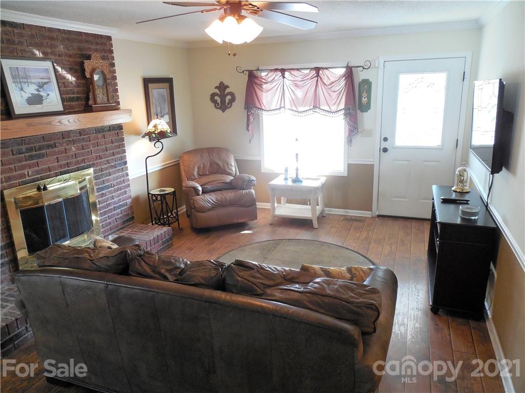 705 Washington Lane Kannapolis, NC 28083 - Photo 17 of 31 a living room with furniture window and a fireplace