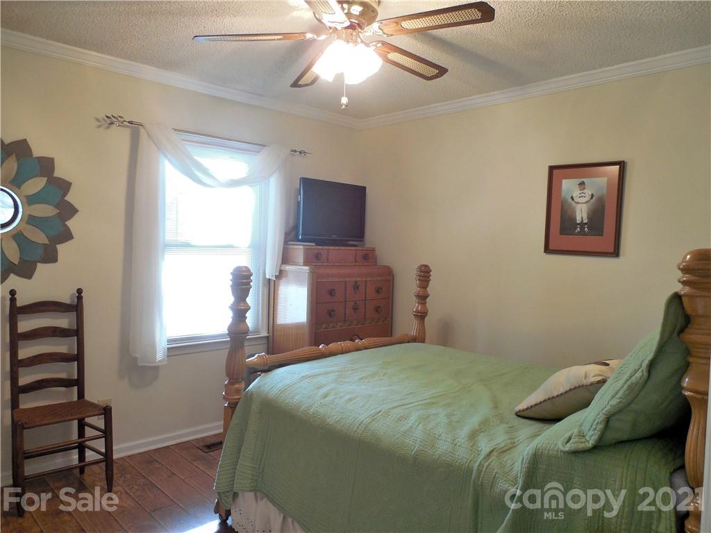 705 Washington Lane Kannapolis, NC 28083 - Photo 18 of 31 a bedroom with a bed and a chandelier