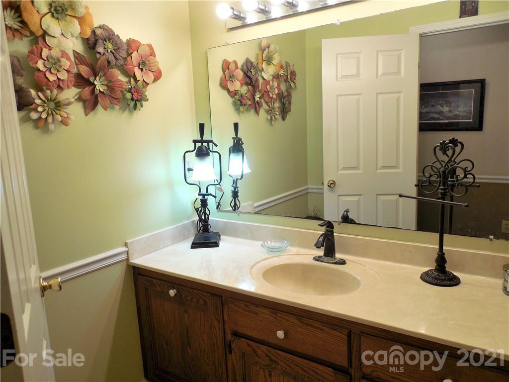 705 Washington Lane Kannapolis, NC 28083 - Photo 20 of 31 a bathroom with a sink and a mirror