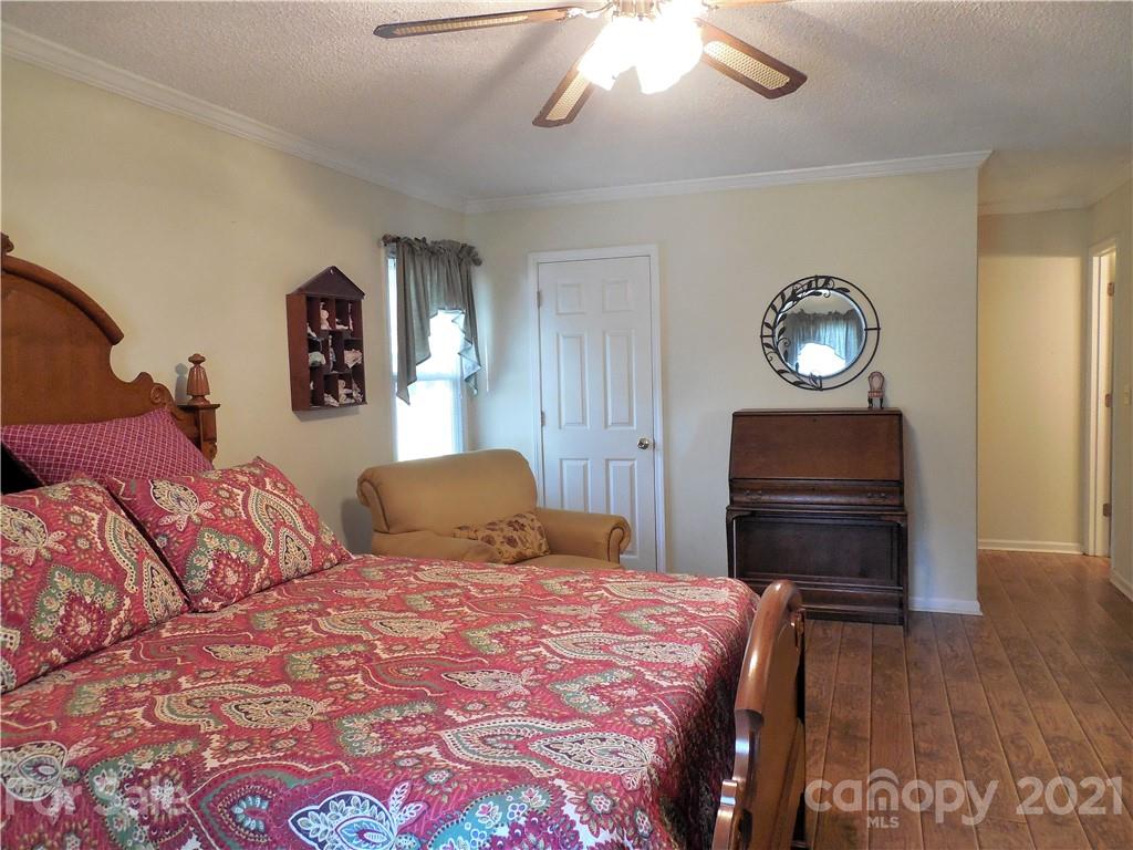 705 Washington Lane Kannapolis, NC 28083 - Photo 22 of 31 a bedroom with a bed and a chandelier