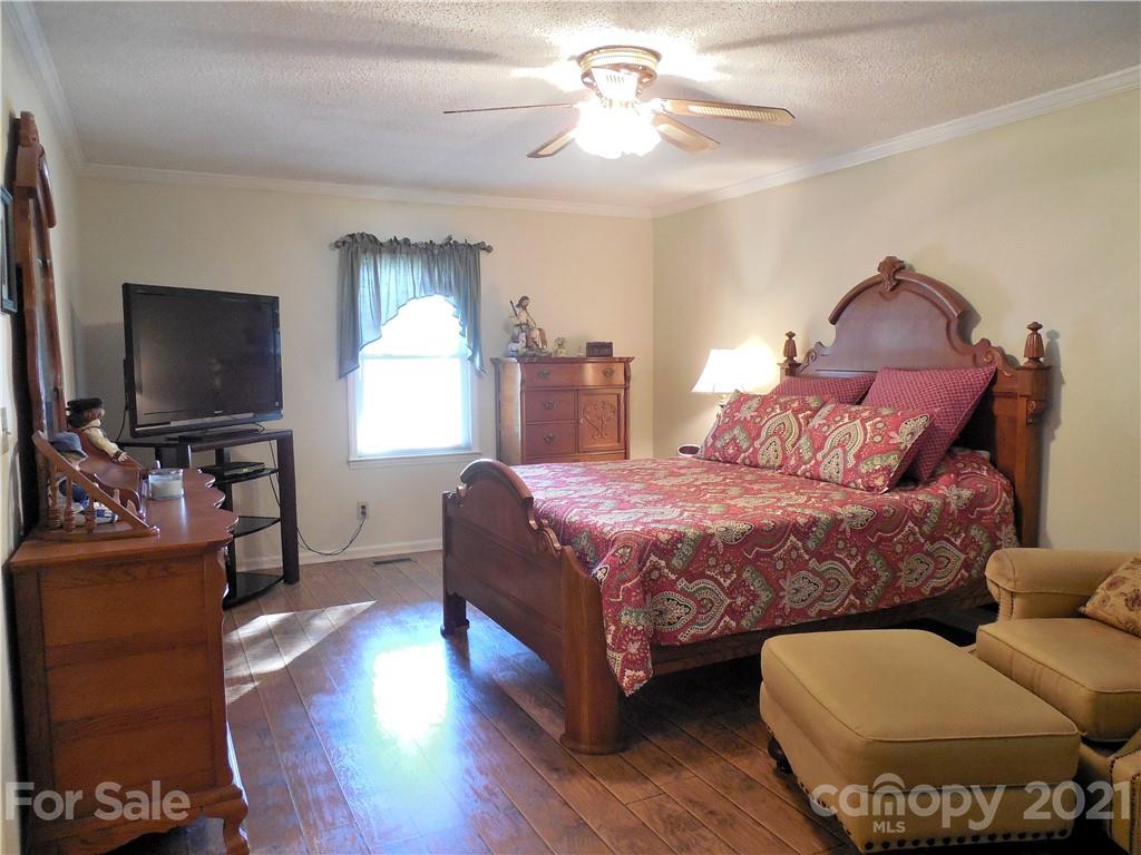 705 Washington Lane Kannapolis, NC 28083 - Photo 23 of 31 a bedroom with a bed and a flat screen tv