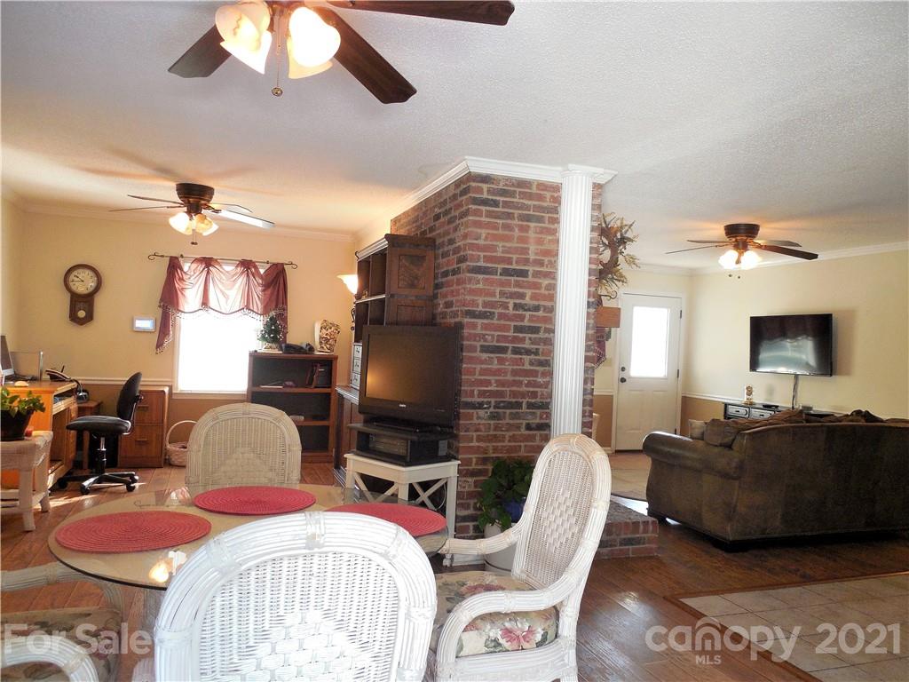 705 Washington Lane Kannapolis, NC 28083 - Photo 8 of 31 a living room with furniture a flat screen tv and a fireplace