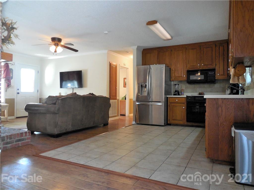 705 Washington Lane Kannapolis, NC 28083 - Photo 9 of 31 a living room with furniture a kitchen island a sink a stove and a refrigerator