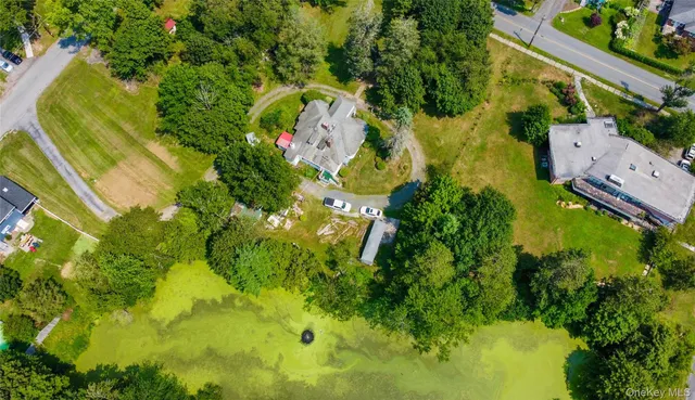 an aerial view of residential houses with yard