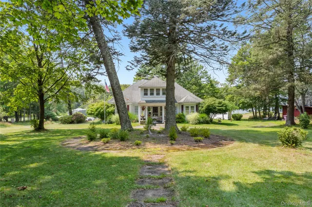 a view of a big yard next to a large trees