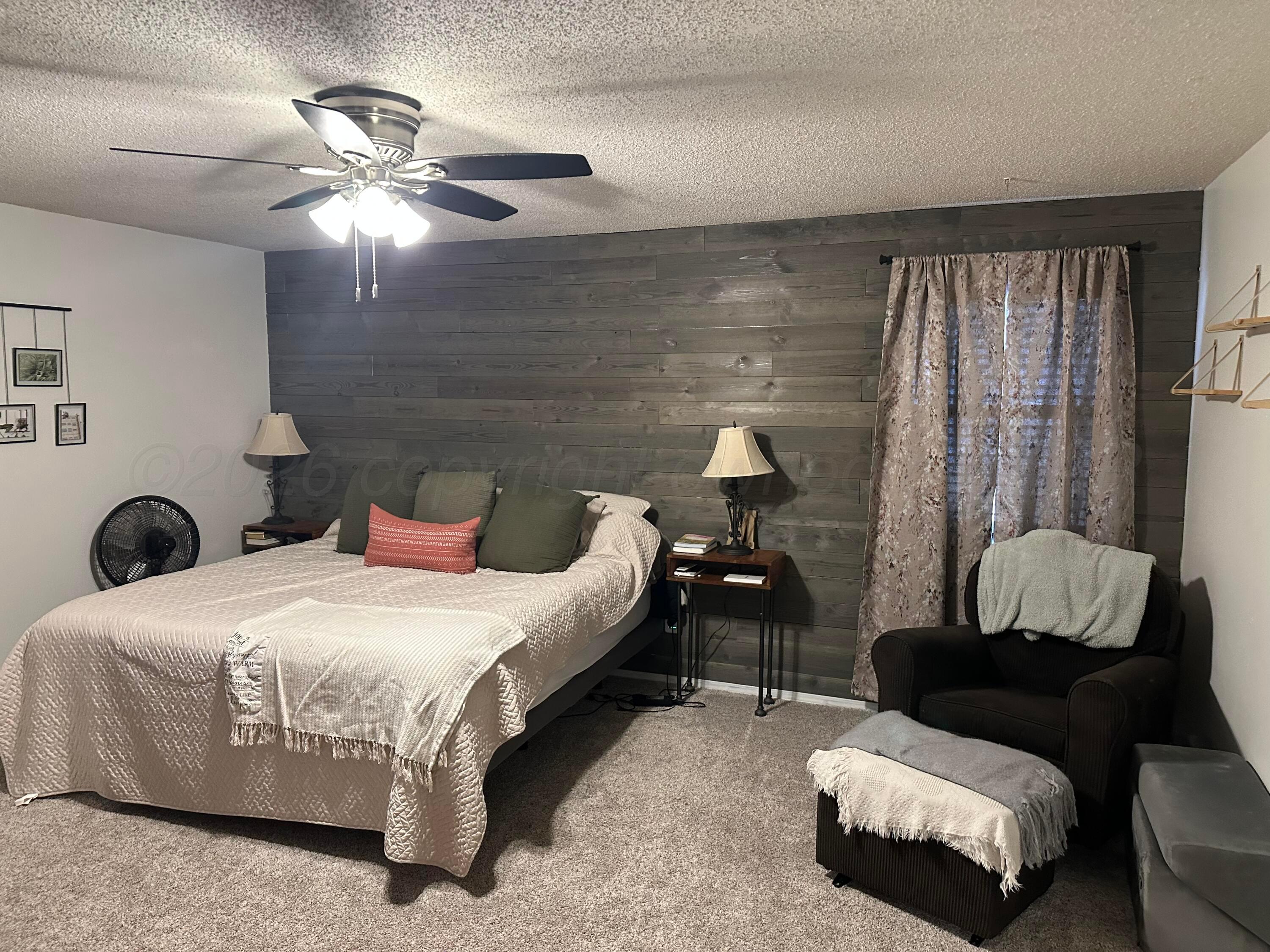 103 Somerset Street Borger, TX 79007 - Photo 16 of 23 a bedroom with a bed and a chandelier