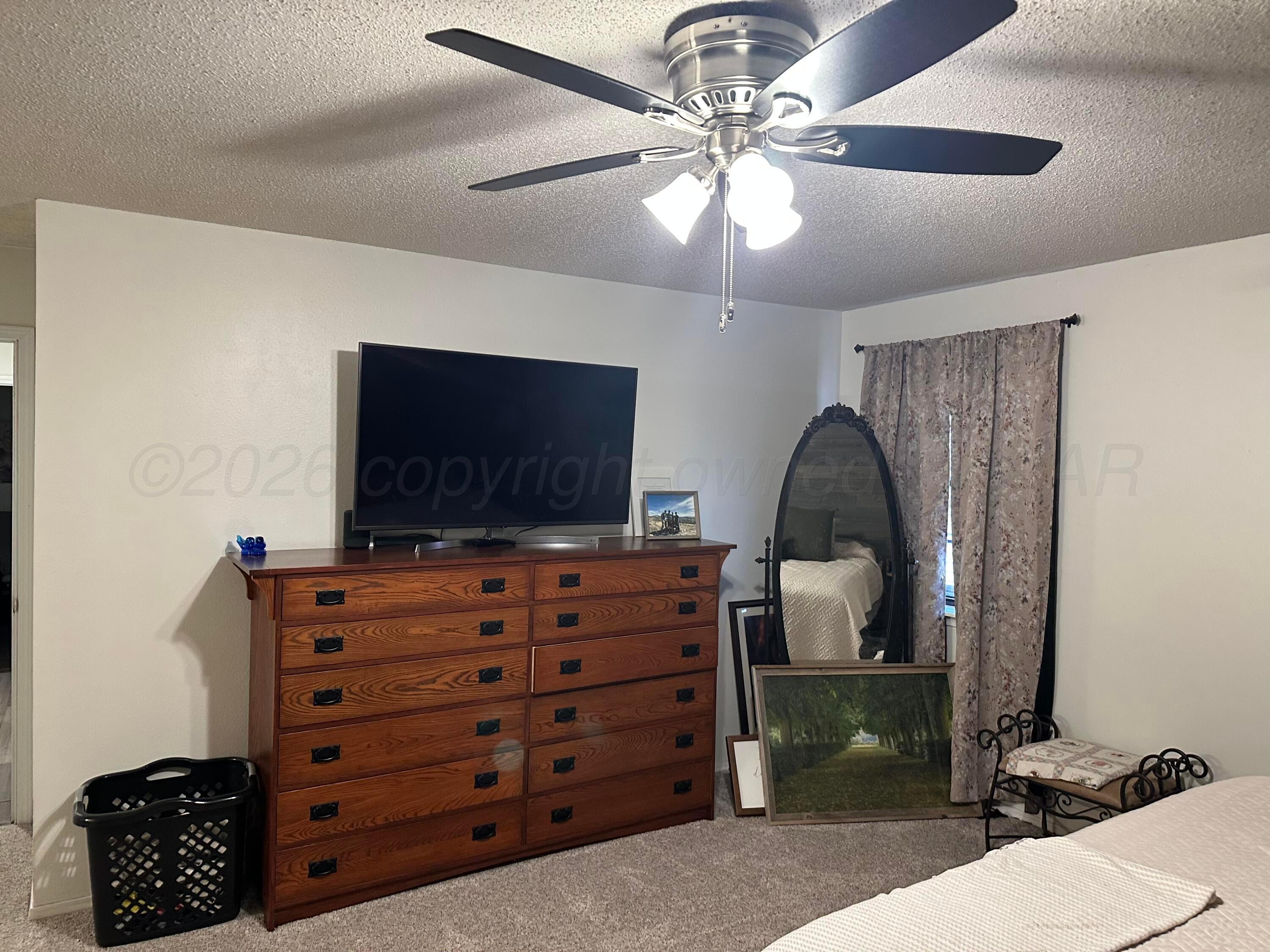 103 Somerset Street Borger, TX 79007 - Photo 17 of 23 a room with furniture and a flat screen tv