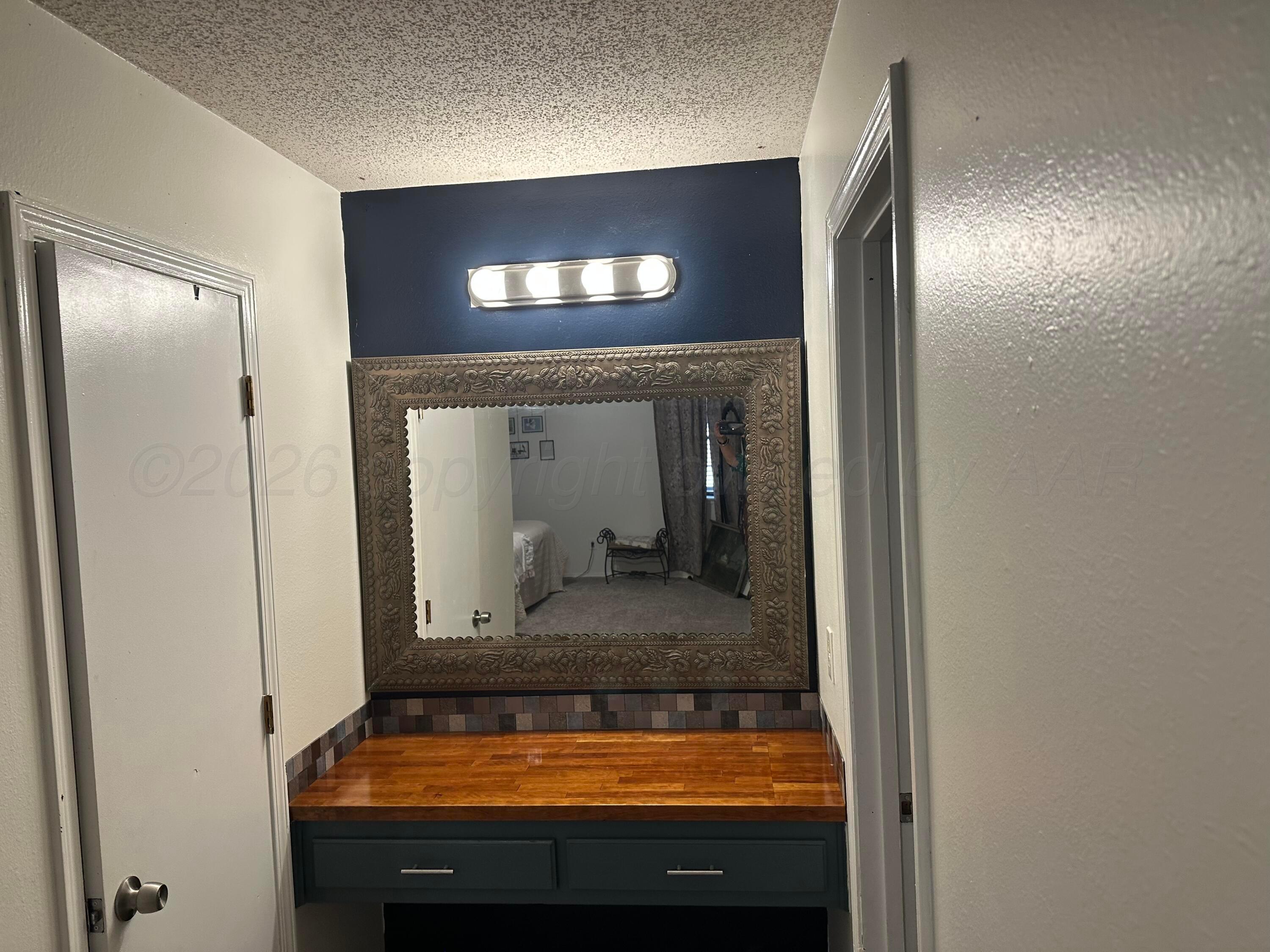 103 Somerset Street Borger, TX 79007 - Photo 18 of 23 a view of bathroom with a sink and mirror