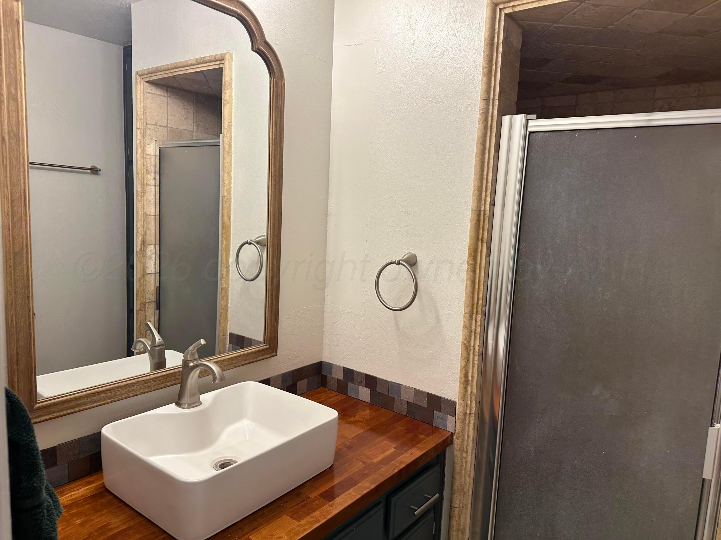 103 Somerset Street Borger, TX 79007 - Photo 19 of 23 a bathroom with a sink and a mirror