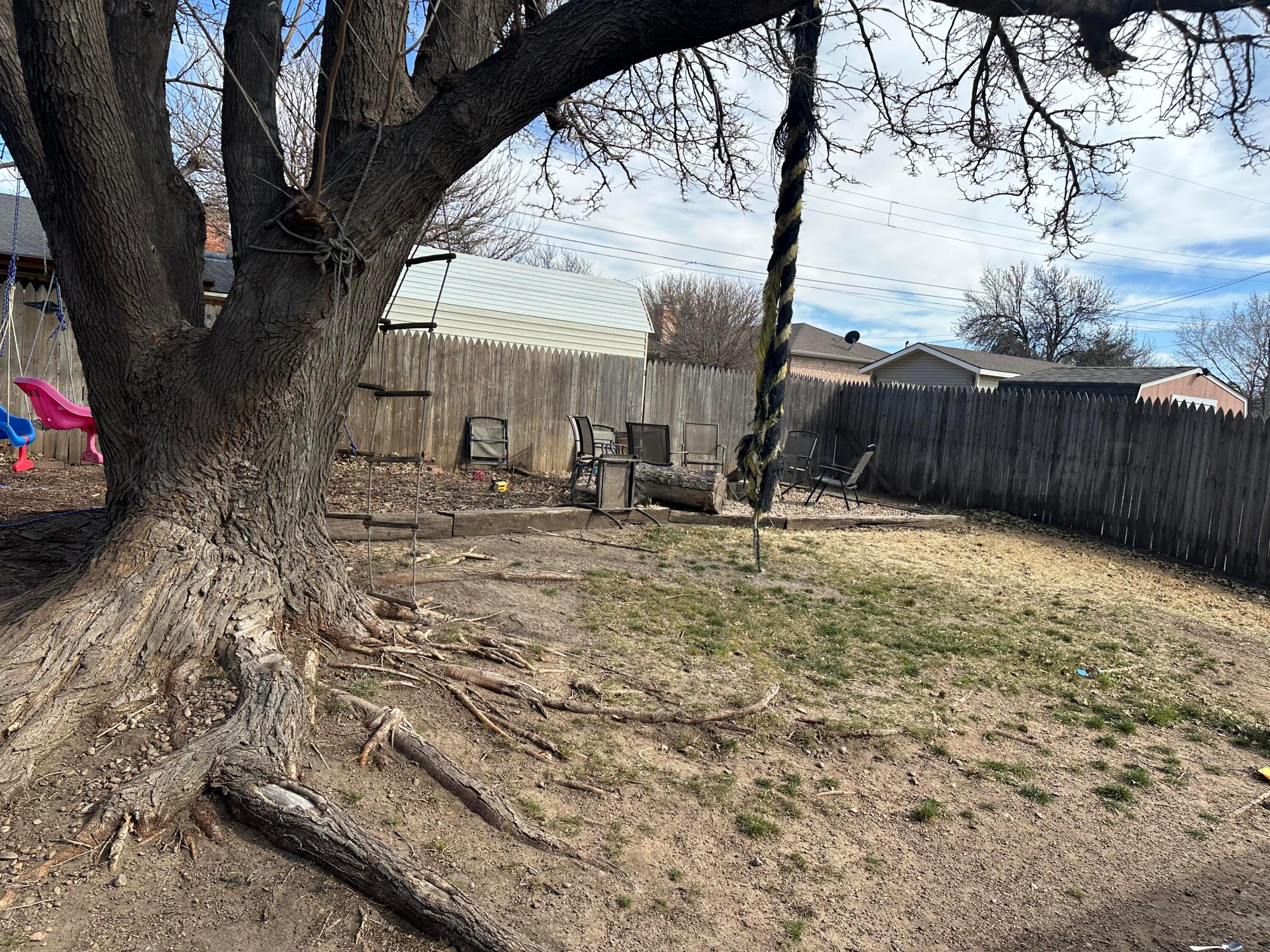 103 Somerset Street Borger, TX 79007 - Photo 21 of 23 a view of backyard with wooden fence