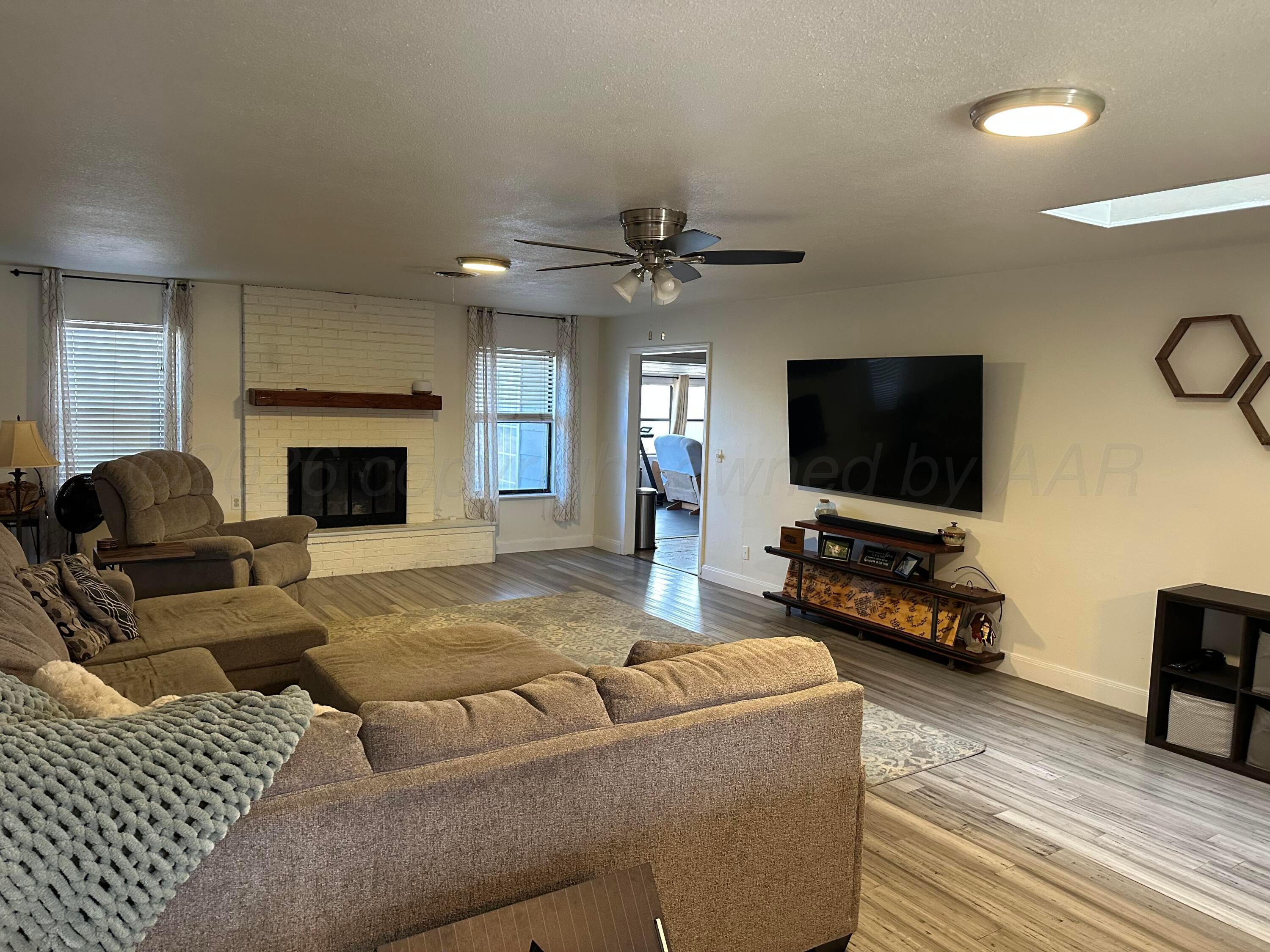 103 Somerset Street Borger, TX 79007 - Photo 4 of 23 a living room with furniture and a flat screen tv