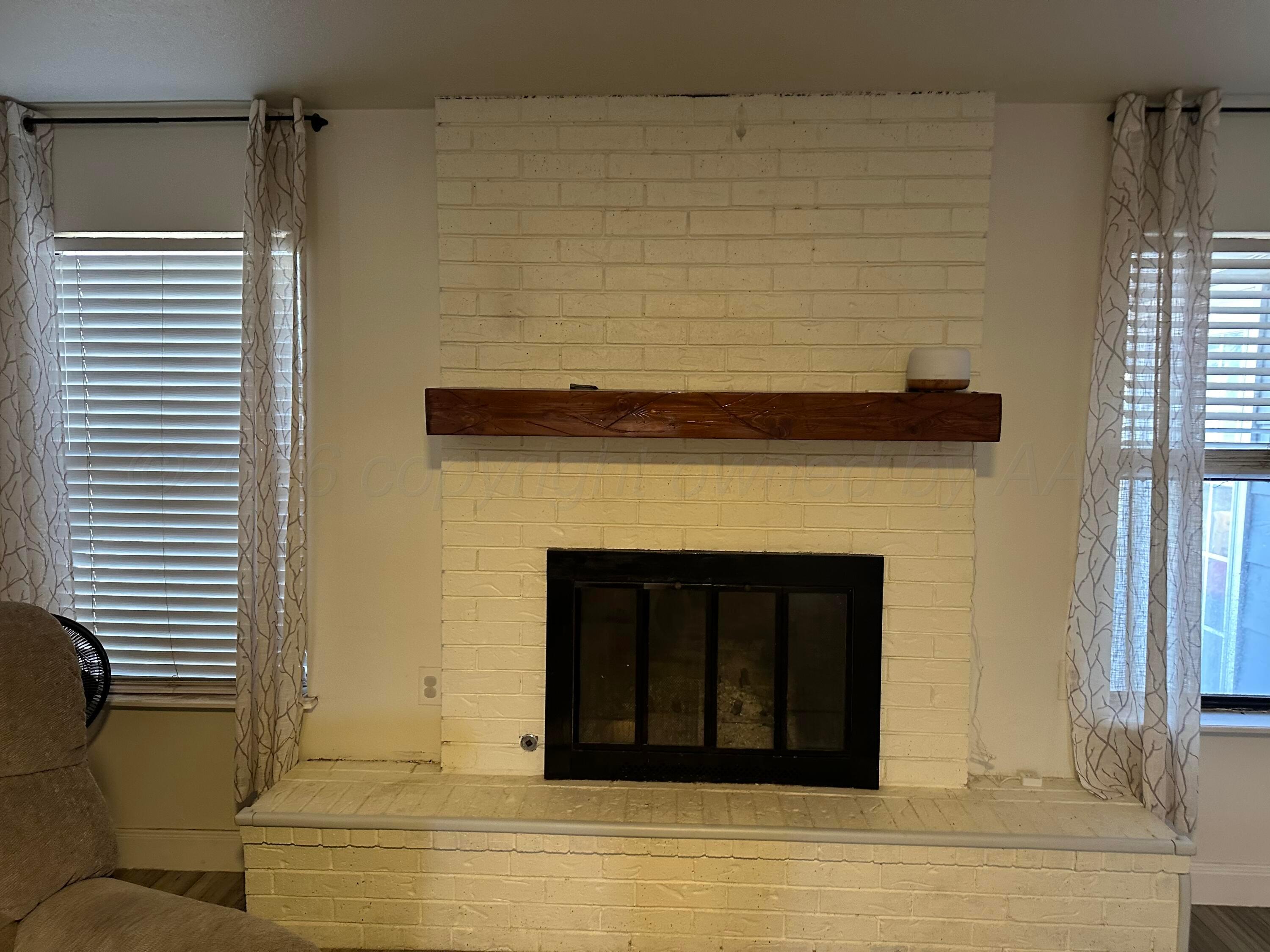 103 Somerset Street Borger, TX 79007 - Photo 5 of 23 a view of a livingroom with a fireplace and window