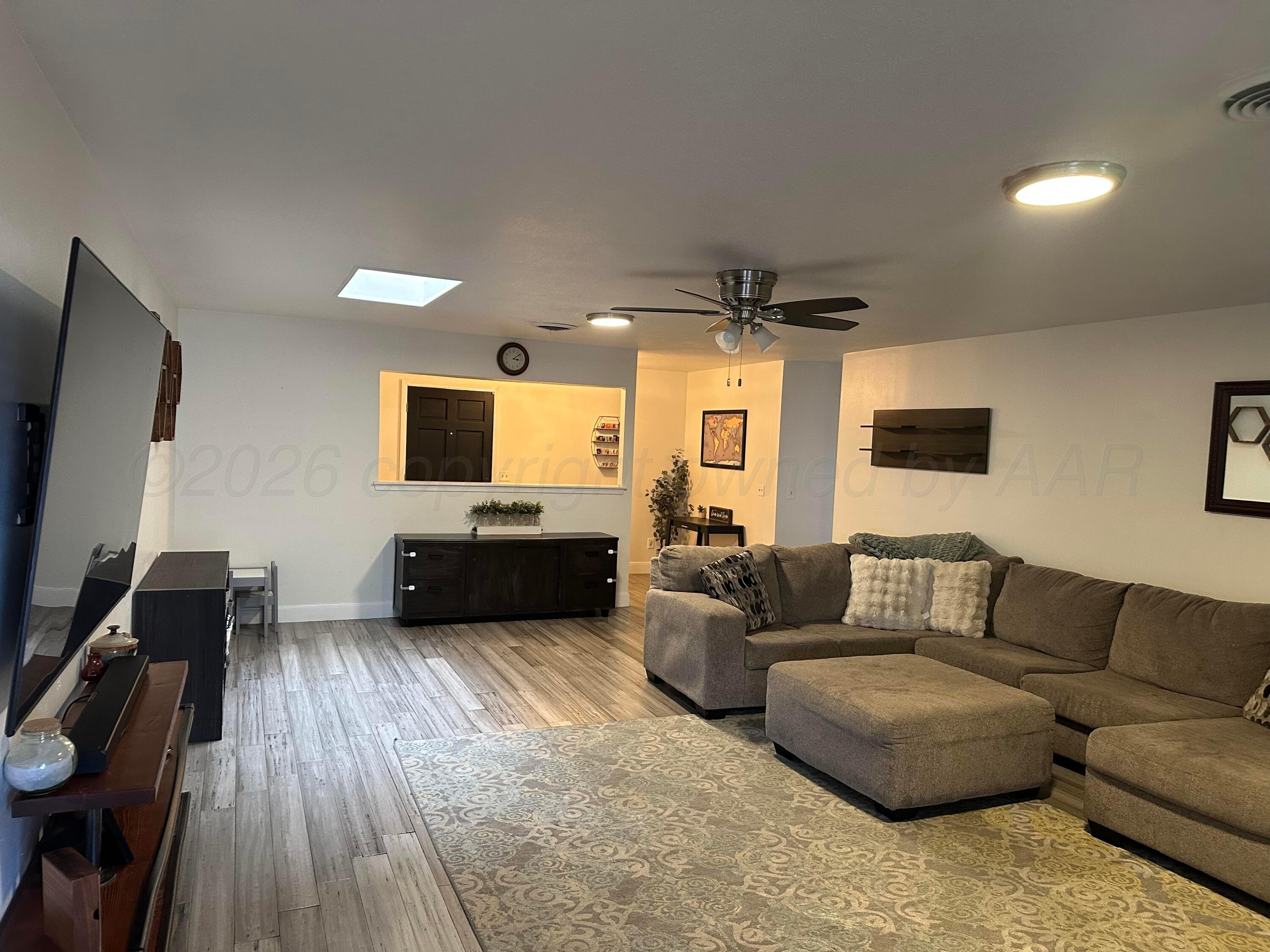 103 Somerset Street Borger, TX 79007 - Photo 6 of 23 a living room with furniture and a flat screen tv