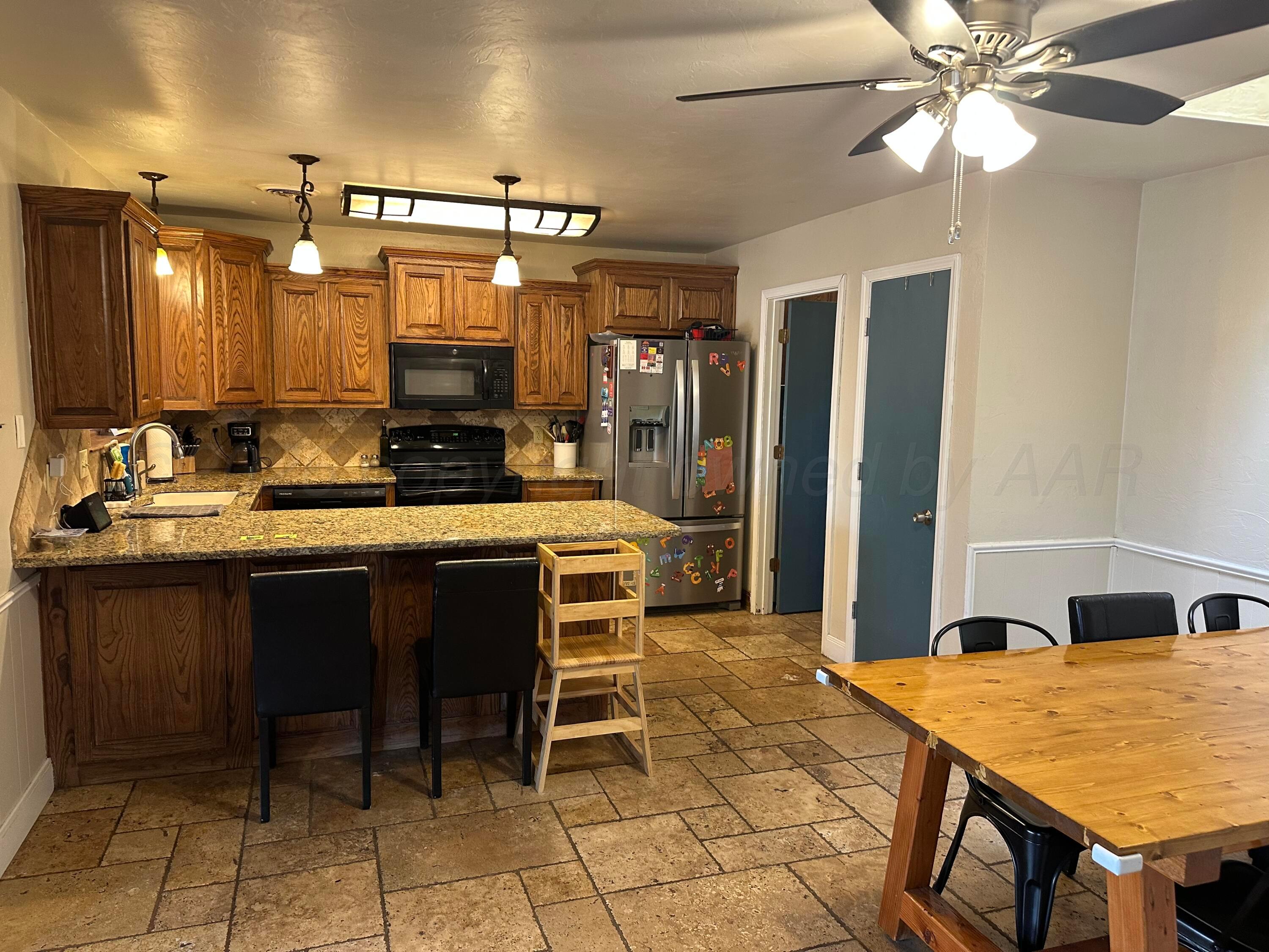 103 Somerset Street Borger, TX 79007 - Photo 7 of 23 a kitchen with a dining table cabinets and appliances