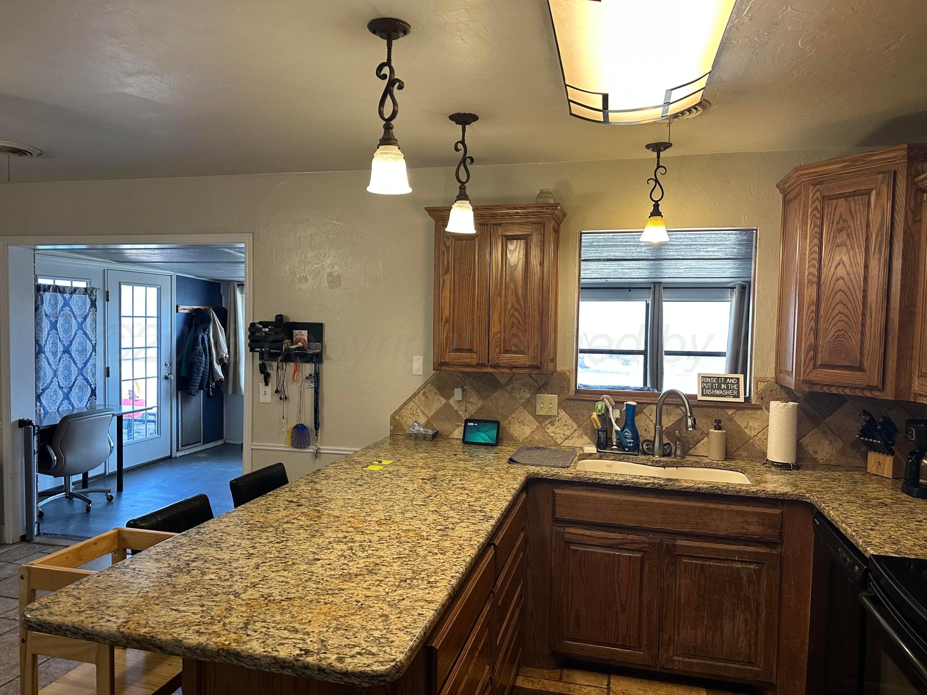 103 Somerset Street Borger, TX 79007 - Photo 9 of 23 a kitchen with sink and refrigerator