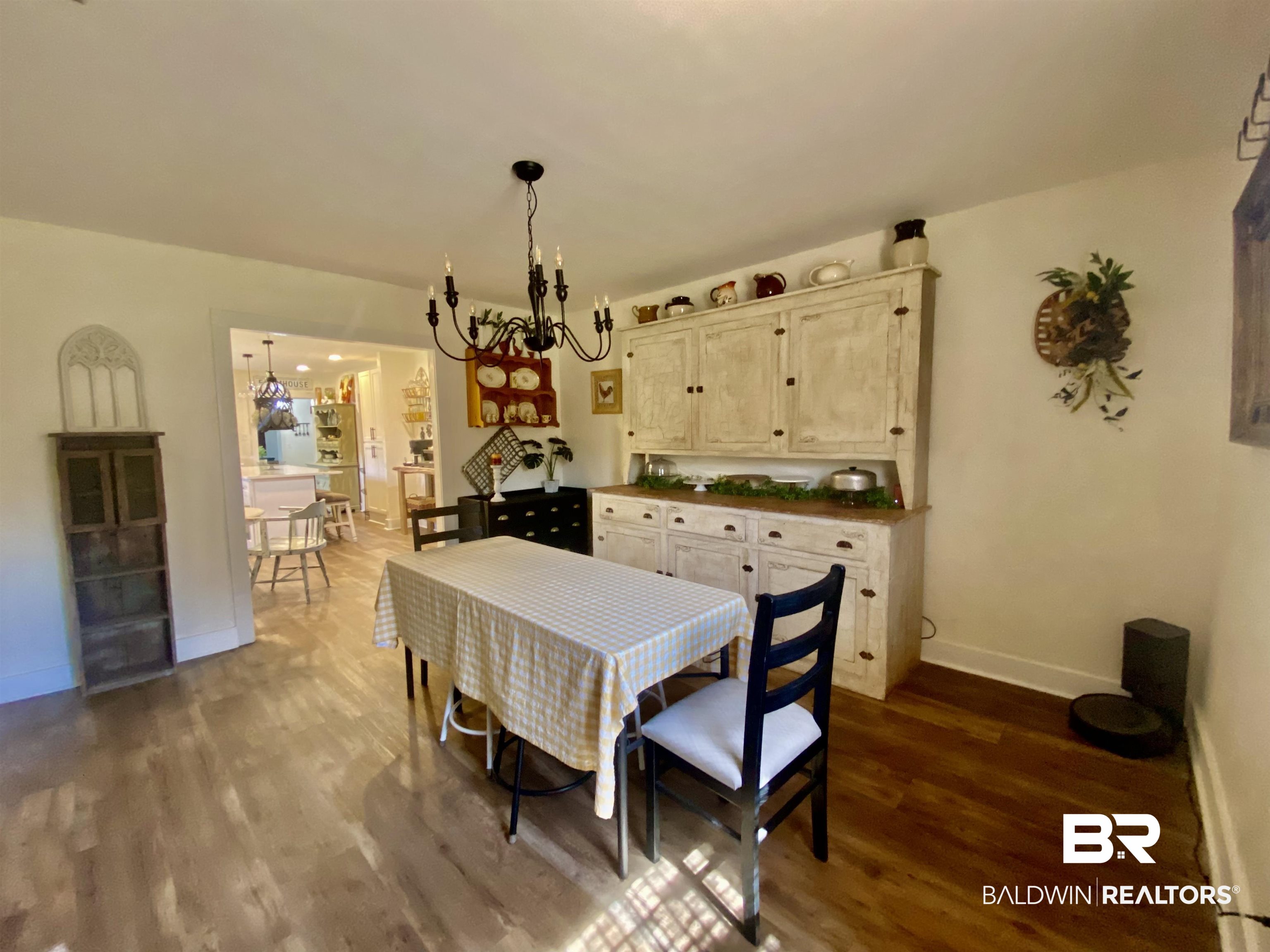 531 Highway 136 Monroeville, AL 36460 - Photo 22 of 48 Dining room with wood-type flooring and a notable chandelier