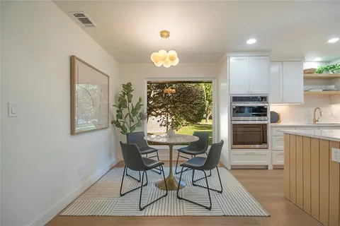 a view of a kitchen with a dining table and chairs