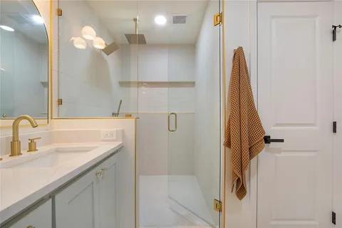 a bathroom with a sink a mirror and a shower
