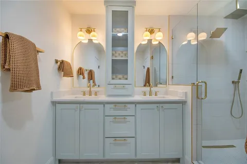 a bathroom with a double vanity sink and a mirror